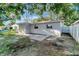 A backyard view showcases the property's patio area and surrounding trees at 3111 W Douglas St, Tampa, FL 33607