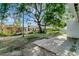 Backyard featuring a spacious brick patio area and shade trees at 3111 W Douglas St, Tampa, FL 33607