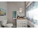 Bright bathroom featuring granite vanity, and a decorative shower curtain at 3111 W Douglas St, Tampa, FL 33607