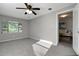 Inviting bedroom with carpet floors, a ceiling fan, and lots of natural light at 3111 W Douglas St, Tampa, FL 33607