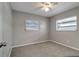 Comfortable bedroom featuring carpet, natural light, and a ceiling fan at 3111 W Douglas St, Tampa, FL 33607