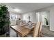 Dining room with a plant, a window, and a wooden table with four chairs at 3111 W Douglas St, Tampa, FL 33607