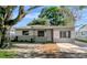 Charming single-story home featuring a well-maintained front yard and a freshly painted exterior at 3111 W Douglas St, Tampa, FL 33607