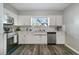 Bright kitchen with stainless steel appliances, white cabinets, and ample counter space at 3111 W Douglas St, Tampa, FL 33607