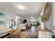 Bright living room boasts stylish decor, wood floors, and plenty of space for entertaining at 3111 W Douglas St, Tampa, FL 33607