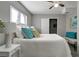 Relaxing bedroom featuring bedside tables, large windows, and cozy bedding at 3111 W Douglas St, Tampa, FL 33607