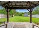 A backyard with a shed and green grass, seen from the covered patio at 3135 W Varn Ave, Tampa, FL 33611