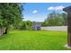 A spacious backyard with a shed, surrounded by trees at 3135 W Varn Ave, Tampa, FL 33611