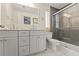 Bathroom with double sink vanity, toilet and glass shower at 3135 W Varn Ave, Tampa, FL 33611