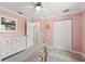 A serene bedroom with light pink walls, a dresser, and closet at 3135 W Varn Ave, Tampa, FL 33611