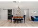 Dining area with a wooden table, black chairs and modern light fixture at 3135 W Varn Ave, Tampa, FL 33611