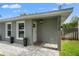 Close-up of front entrance, showing the address, stylish light fixture, and freshly painted facade at 3135 W Varn Ave, Tampa, FL 33611