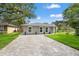Charming single-story home with a well-manicured lawn and paved driveway at 3135 W Varn Ave, Tampa, FL 33611