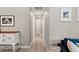 Hallway featuring neutral walls, art, and light wood floors at 3135 W Varn Ave, Tampa, FL 33611