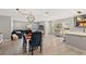 Open-concept living area with dining table, modern lighting, and stylish decor at 3135 W Varn Ave, Tampa, FL 33611