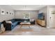 Inviting living room with a plush sectional sofa, stylish rug, and contemporary decor at 3135 W Varn Ave, Tampa, FL 33611