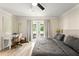Serene main bedroom with desk area and french door access to outdoor patio at 3135 W Varn Ave, Tampa, FL 33611
