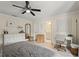 Stylish main bedroom with white dresser, wood floors and ensuite bathroom at 3135 W Varn Ave, Tampa, FL 33611