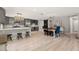 Spacious open floorplan connecting the kitchen, dining area, and living room with luxury vinyl flooring at 3135 W Varn Ave, Tampa, FL 33611