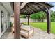 A covered patio features brick floors, an outdoor ceiling fan, and backyard views at 3135 W Varn Ave, Tampa, FL 33611
