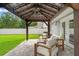 Covered patio area with comfortable seating and a well-manicured lawn at 3135 W Varn Ave, Tampa, FL 33611