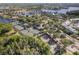 Aerial view of community tennis and basketball courts with lush trees near a lake at 315 Blackrock Ln, Apollo Beach, FL 33572
