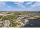 Community aerial view features community amenities, lakes, landscaping, and surrounding residential areas under a blue sky at 315 Blackrock Ln, Apollo Beach, FL 33572