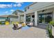 Covered back patio with an outdoor ceiling fan, a lounge area, and large sliding glass doors at 315 Blackrock Ln, Apollo Beach, FL 33572