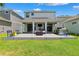 Backyard featuring patio, outdoor kitchen, seating, and green lawn at 315 Blackrock Ln, Apollo Beach, FL 33572