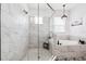 Modern bathroom features a glass-enclosed shower and a luxurious soaking tub at 315 Blackrock Ln, Apollo Beach, FL 33572