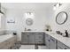 Elegant bathroom with a soaking tub, dual sinks, and patterned tile flooring at 315 Blackrock Ln, Apollo Beach, FL 33572