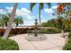 Outdoor shot of a beautiful stone fountain on a brick patio surrounded by lush landscaping, water view at 315 Blackrock Ln, Apollo Beach, FL 33572