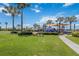 Community playground with swings, slides, and a covered play structure, surrounded by palm trees at 315 Blackrock Ln, Apollo Beach, FL 33572