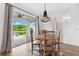 Cozy dining area boasts wood-look tile flooring and sliding glass doors to the patio at 315 Blackrock Ln, Apollo Beach, FL 33572