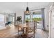 Bright dining area features modern lighting and sliding glass doors leading to outdoor patio at 315 Blackrock Ln, Apollo Beach, FL 33572