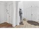 Elegant foyer with hardwood floors, white walls, and decorative knight statue at 315 Blackrock Ln, Apollo Beach, FL 33572