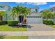 Charming two-story home with a two-car garage, lush landscaping, and a paved driveway at 315 Blackrock Ln, Apollo Beach, FL 33572