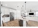 Bright kitchen with stainless steel appliances, island with breakfast bar, and open layout to the living area at 315 Blackrock Ln, Apollo Beach, FL 33572