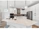 Well-equipped kitchen with large island, pendant lights, and stainless steel appliances at 315 Blackrock Ln, Apollo Beach, FL 33572