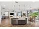 Open-concept kitchen featuring an island with a farmhouse sink and views into the living area at 315 Blackrock Ln, Apollo Beach, FL 33572