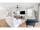 Comfortable living room features a large TV, and wood-look flooring at 315 Blackrock Ln, Apollo Beach, FL 33572
