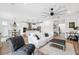 Open-concept living room showcases modern décor, wood-look tile flooring, and seamless flow to the kitchen at 315 Blackrock Ln, Apollo Beach, FL 33572