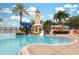 Community pool area showcases lighthouse themed slide, wading area, palm trees, and well-maintained landscaping at 315 Blackrock Ln, Apollo Beach, FL 33572