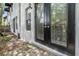 Back exterior of home with black framed french doors accessing private outdoor living at 3210 W Horatio St # 9, Tampa, FL 33609
