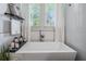 Stylish bathroom featuring a soaking tub with views of the outdoors and modern fixtures at 3210 W Horatio St # 9, Tampa, FL 33609