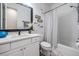Bright bathroom features a vanity with a white countertop and a shower with a striped curtain at 3210 W Horatio St # 9, Tampa, FL 33609