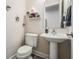 Stylish half-bathroom with floating shelves, modern fixtures, and a pedestal sink at 3210 W Horatio St # 9, Tampa, FL 33609