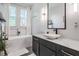 Bright bathroom featuring a vanity with modern fixtures, a soaking tub, and great natural light at 3210 W Horatio St # 9, Tampa, FL 33609