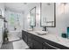 Modern bathroom featuring dual vanity sinks, a soaking tub, and great natural light at 3210 W Horatio St # 9, Tampa, FL 33609