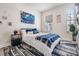Cozy bedroom with large window, patterned rug, blue accents, and lots of natural light at 3210 W Horatio St # 9, Tampa, FL 33609